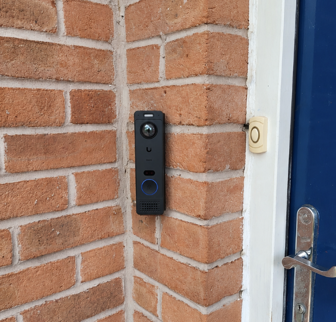 Ubiquiti G6 Entry smart doorbell installed beside an entrance
